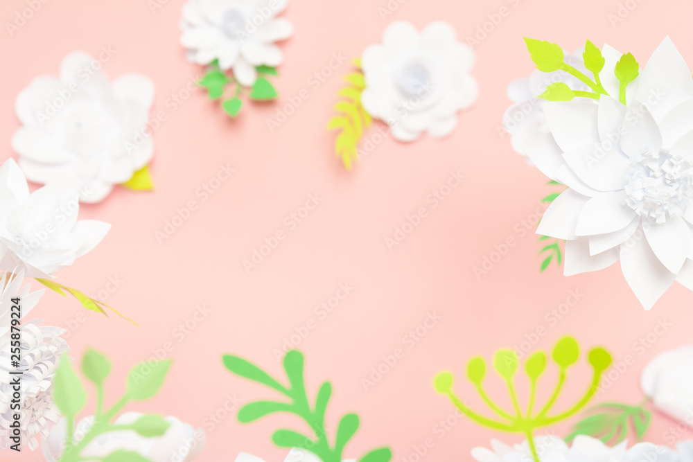 White paper flowers on pink background. Floral