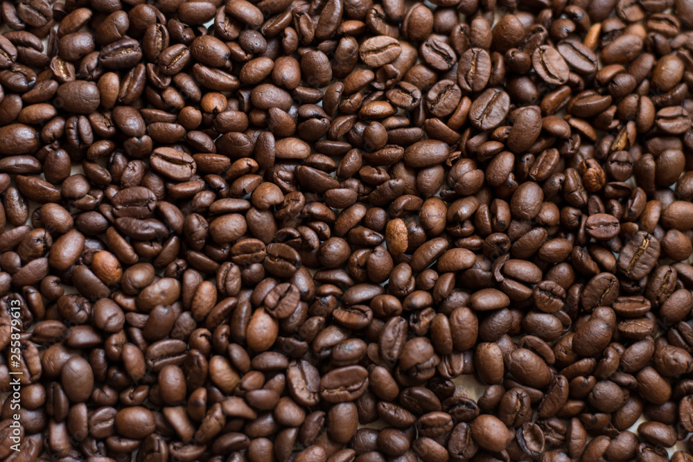 Texture of coffee beans scattered randomly. Brown texture. Texture of coffee beans scattered randomly. Brown texture.