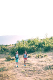 Two women are traveling through the mountains.
