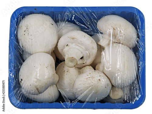 White mushrooms wrapped with foil in a blue bowl, top view