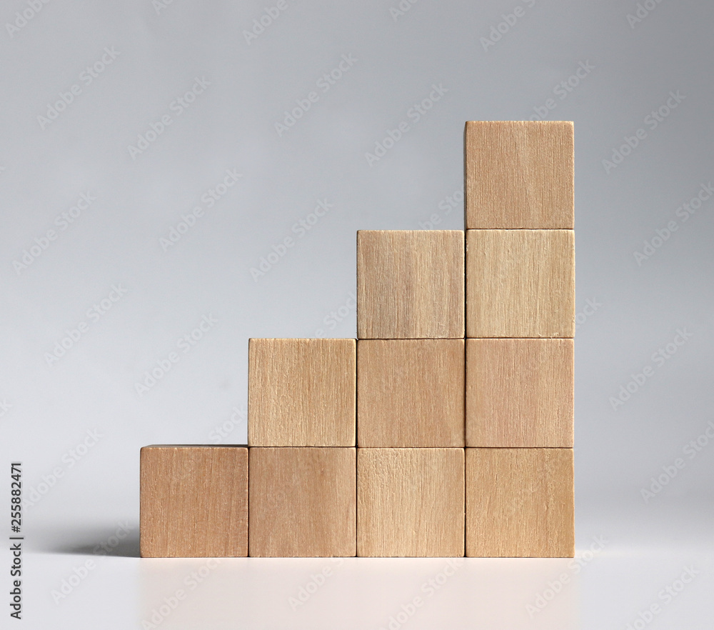 A stack of wooden blocks stacked in the shape of a staircase. Stock Photo |  Adobe Stock