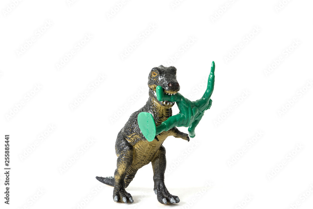 plastic dinosaur fighting with a toy soldier plastic dinosaur fighting with a toy soldier