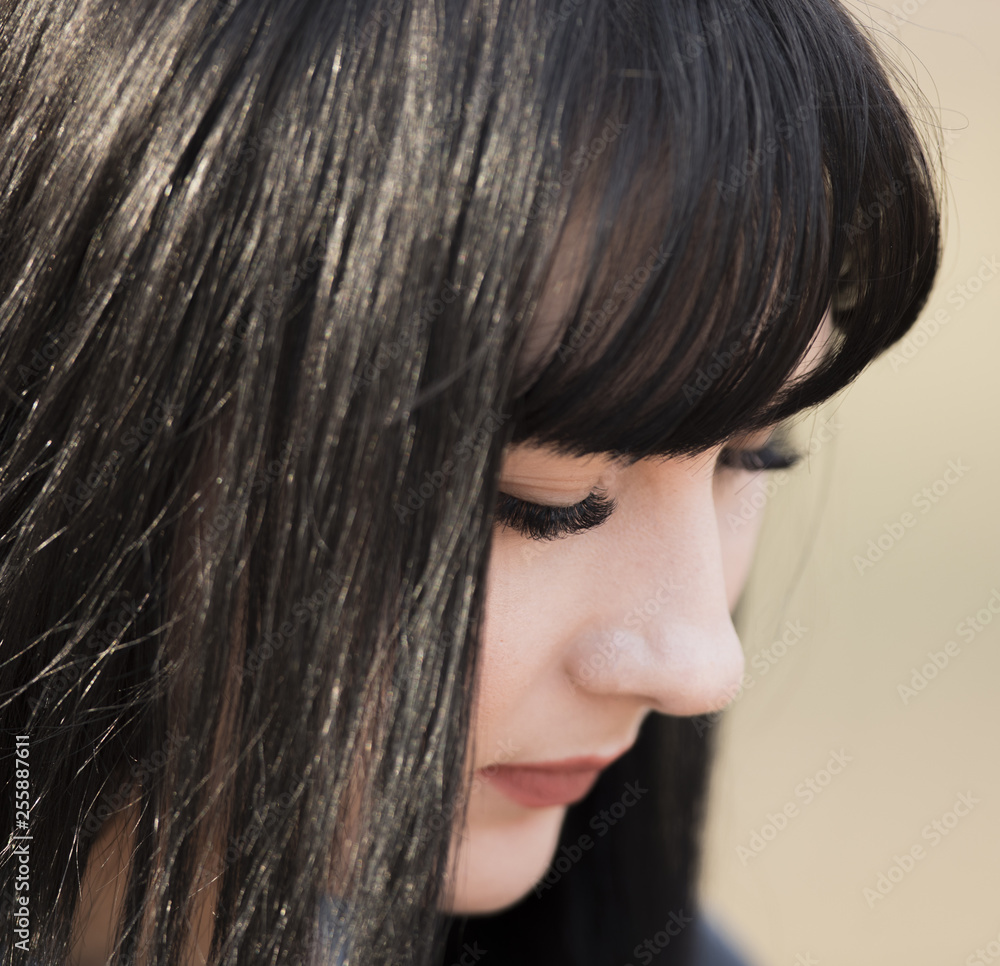 closeup profile portrait of a beautiful brunette young girl closeup profile portrait of a beautiful brunette young girl