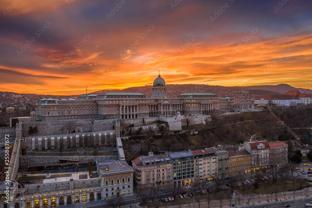 Budapest, Hungary - Aerial view of Buda Castle Royal Palace with a dramatic golden sunset at winter time