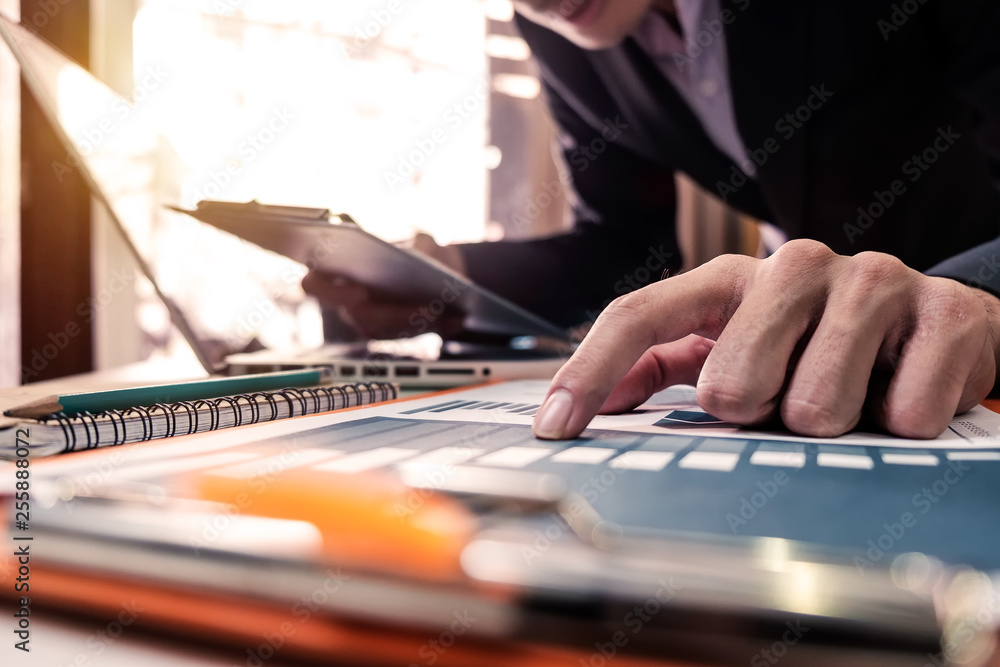 businessman hand using smart phone, tablet payments and holding credit card online shopping, omni channel, digital tablet docking keyboard computer at office in sun light businessman hand using smart phone, tablet payments and holding credit card online shopping, omni channel, digital tablet docking keyboard computer at office in sun light