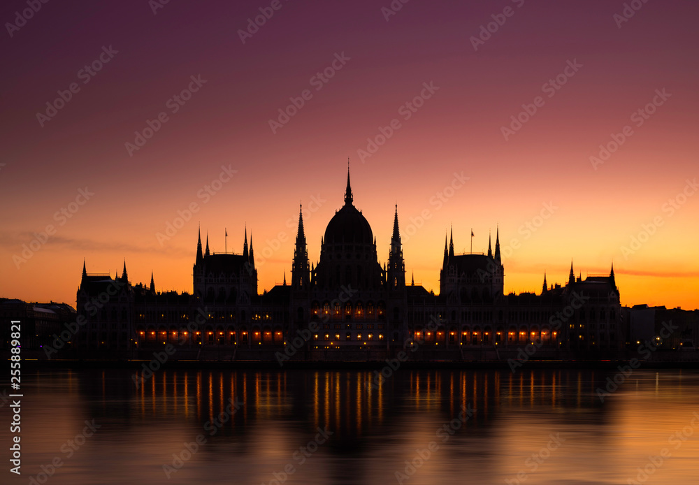 Budapest, Hungary - The Hungarian Parliament building on a colorful winter dawn with golden and red sky and River Danube