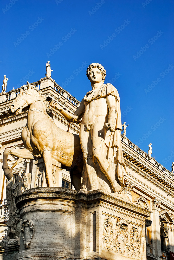 Marble statue of Castor Dioscuri. The sculpture is located on Michelangelo Cordonata stairs and leading to Piazza del Campidoglio. Rome, Italy 