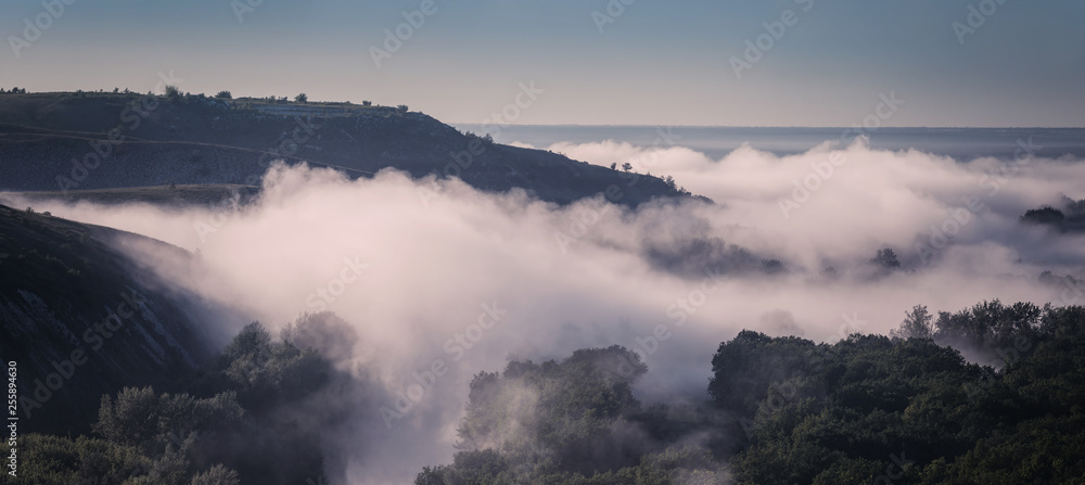 Panorama with fog over hills