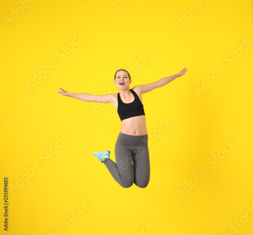 Young sporty woman jumping ...