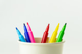 colorful of color pen in white paper coffee cup.
