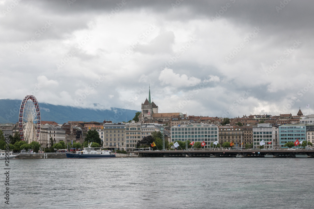 View on Geneva lake, far away mountains and city Geneva, Switzerland