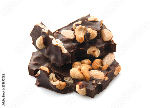 Tasty dark chocolate with nuts on white background