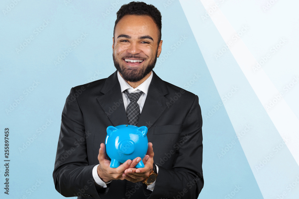 African American business man holding a piggy bank African American business man holding a piggy bank