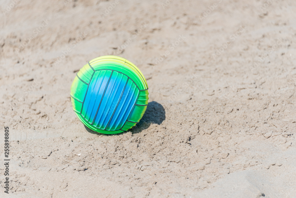 Bright Beach Ball on a Sandy Beach on a Sunny Day Bright Beach Ball on a Sandy Beach on a Sunny Day