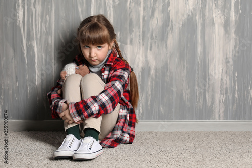 Sad little girl sitting on ...