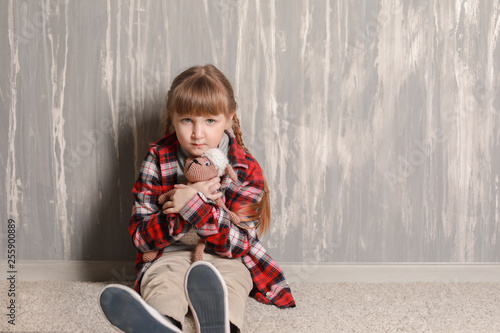 Sad little girl sitting on ...