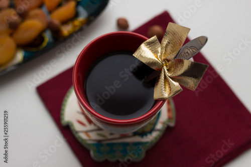 cup of coffee with red ribbon and bow