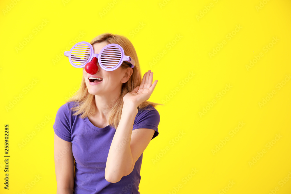 Funny woman with party decor for April Fools' Day on color background Funny woman with party decor for April Fools' Day on color background