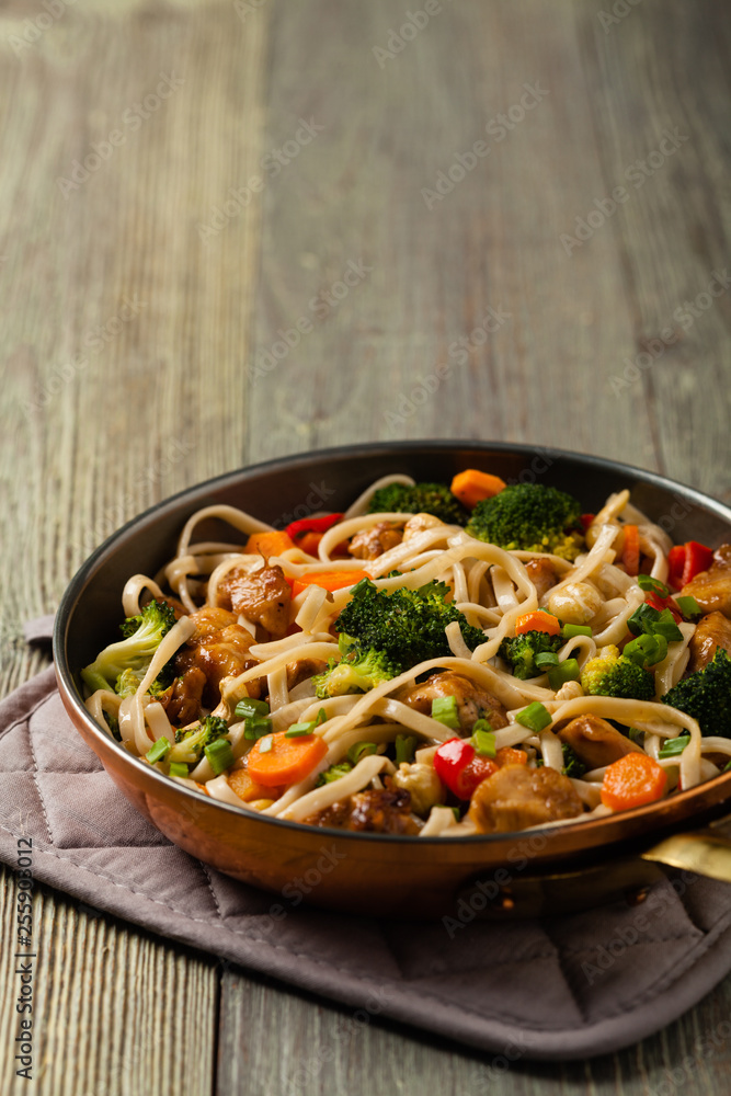 stir-fry pasta with chicken, broccoli and carrots. stir-fry pasta with chicken, broccoli and carrots.