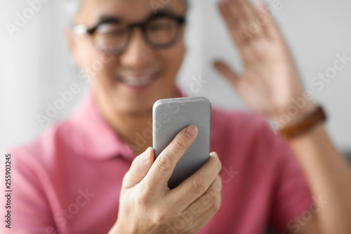 technology, people and communication concept - close up of happy man having video call on smartphone