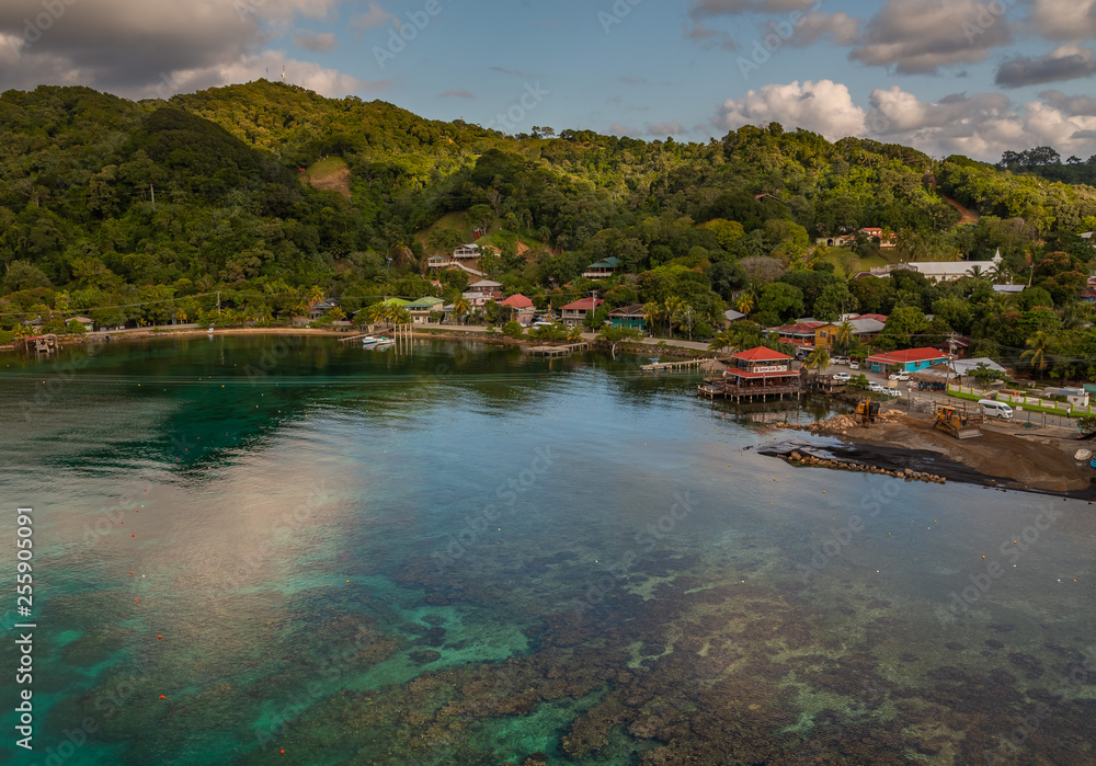 Port of Roatan in the Hondures. Exposure of the Roatan port with its beautiful water, seen from a cruise ship, during morning with heavy clouds in the horizon. 