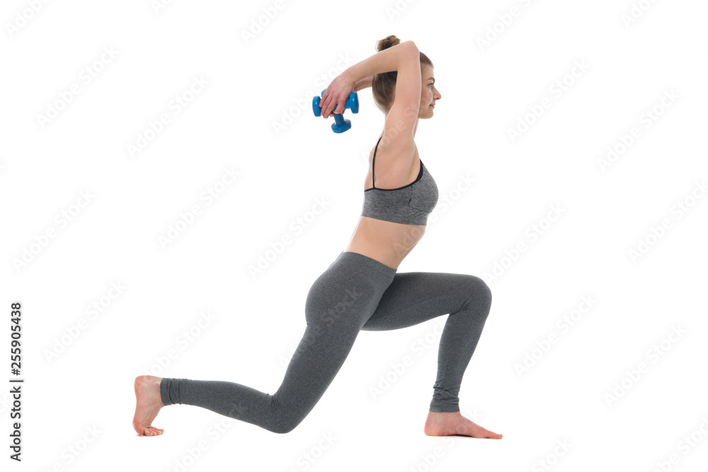 Slim girl with dumbbells in her hands is engaged in fitness isolated on a white background.