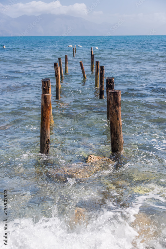 Old Posts for Dock into the Mediterranean Sea on the Southern Italian Coast Old Posts for Dock into the Mediterranean Sea on the Southern Italian Coast