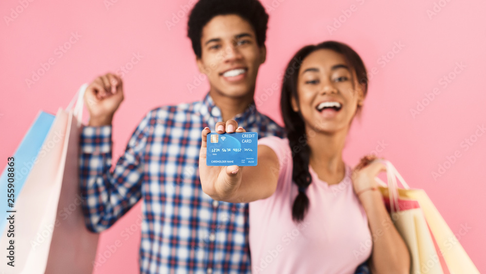 Teenagers with shopping bags and credit card