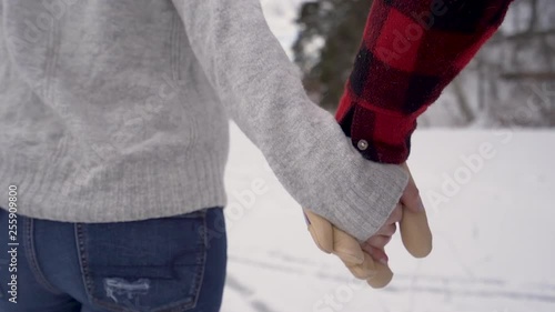 Close up of hands of couple ice skating in slow motion photo