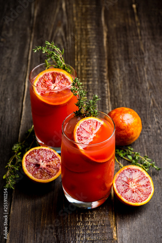 Bloody oranges beverage with thyme. Selective focus. Shallow depth of field.