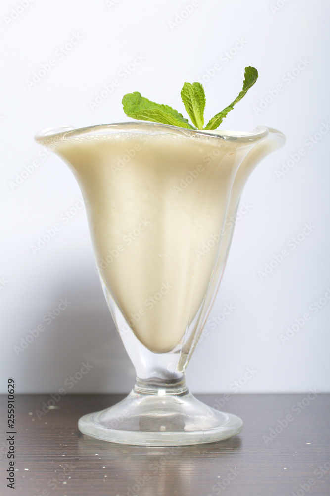 Ice-cream bowl with sour cream jelly. Decorated with mint leaves. Ice-cream bowl with sour cream jelly. Decorated with mint leaves.