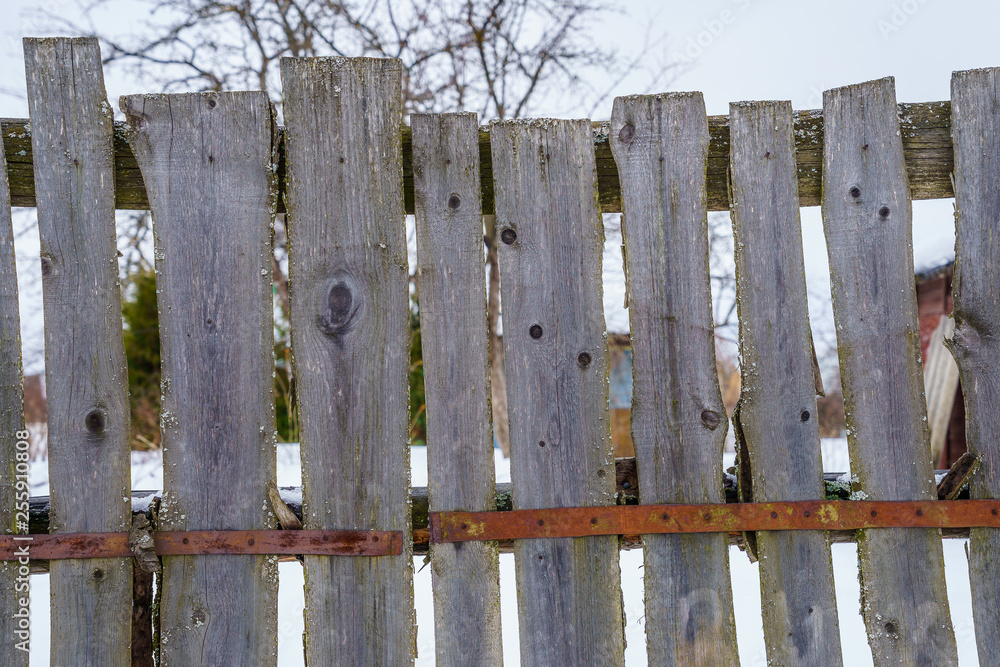 wooden fence of boards nailed to the crossbar wooden fence of boards nailed to the crossbar