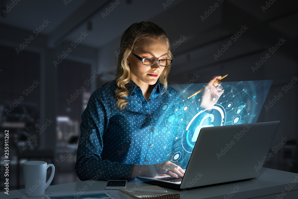 Beautiful blonde in dark office working on laptop and getting net access Beautiful blonde in dark office working on laptop and getting net access