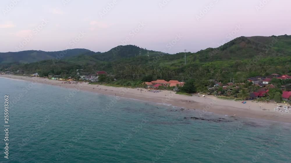 Flying drone over the beach. Andaman sea, Koh Lanta, Thailand. Green seaside; white sand beach; rocks; blue sea; ocean; clear sky; green trees; Flying drone over the beach. Andaman sea, Koh Lanta, Thailand. Green seaside; white sand beach; rocks; blue sea; ocean; clear sky; green trees;