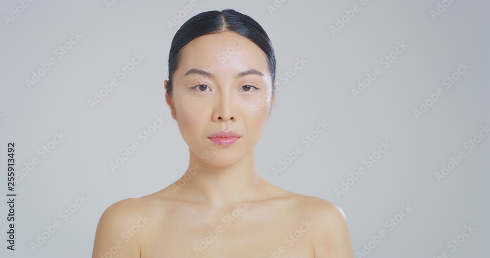 Portrait of asian woman with beautiful face with perfect skin just cleaned from impurities ready for day or night cream is looking in camera. Portrait of asian woman with beautiful face with perfect skin just cleaned from impurities ready for day or night cream is looking in camera.