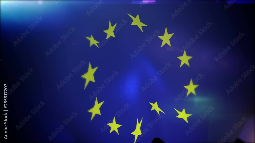 Cheerful 3d rendering of a waving European Union banner with twelve five-angled golden stars in the blue field put in a circle. It looks funny, optimistic, and glorious. Cheerful 3d rendering of a waving European Union banner with twelve five-angled golden stars in the blue field put in a circle. It looks funny, optimistic, and glorious.