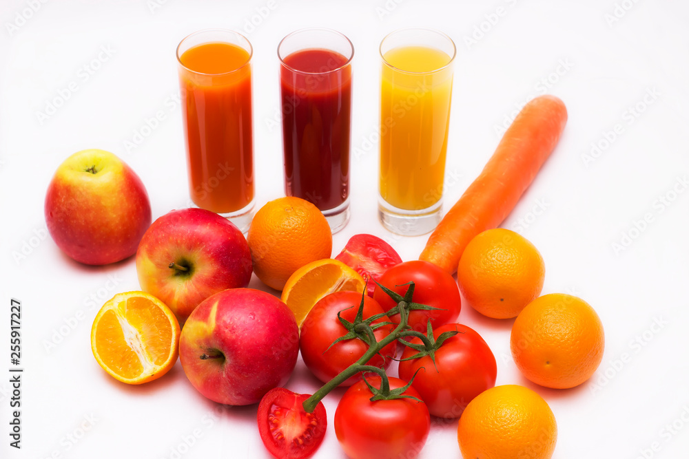 Various vegetable and fruit juices in glass with tomato, carrot, orange and apple background Various vegetable and fruit juices in glass with tomato, carrot, orange and apple background