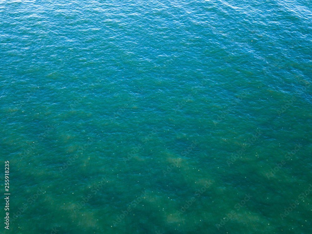 Obraz premium Ocean surface landscape from bird's eye drone view. Natural sea turquoise background. Copy space. Top view.