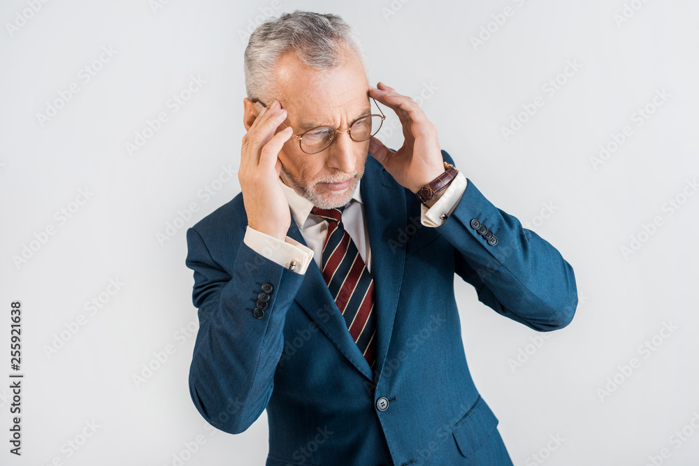 overhead view of mature businessman in suit having headache isolated on grey overhead view of mature businessman in suit having headache isolated on grey