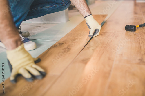 Professional flooring installation - laying a new laminate with a wooden pattern