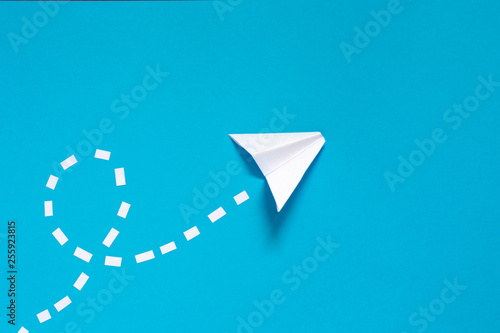 Paper cut plane with on blue background. Concept of travel, airlines, plane, communication, message, telegram, origami, sky.