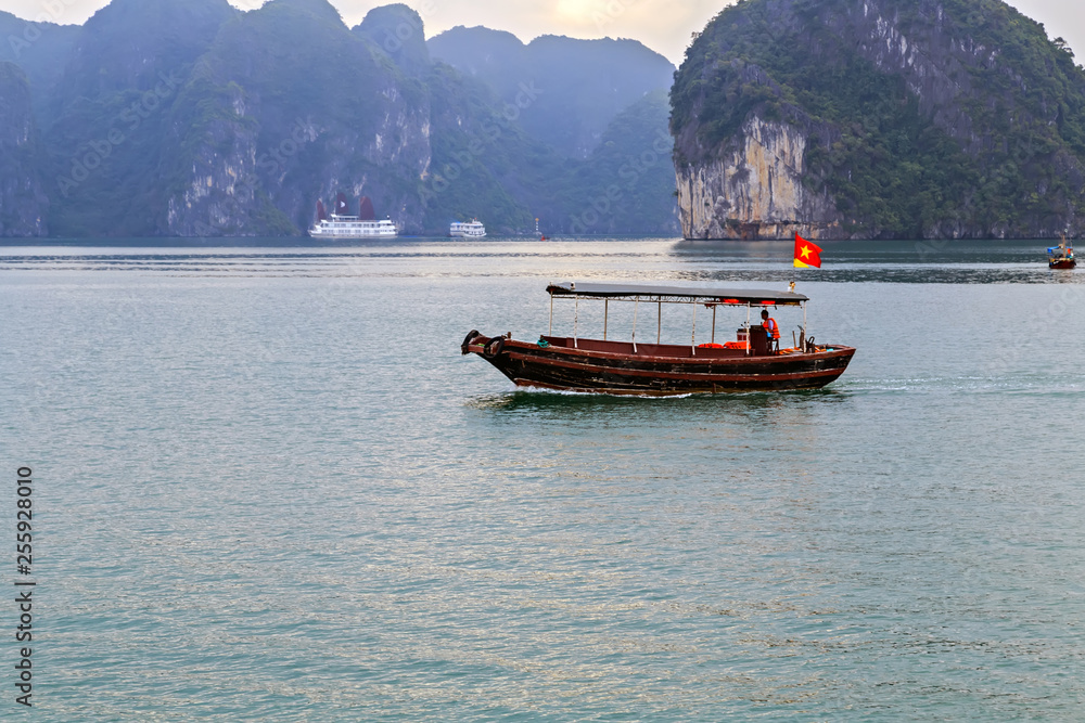 Tourist boat Tourist junks floating limestone rocks Halong Bay in Vietnam.