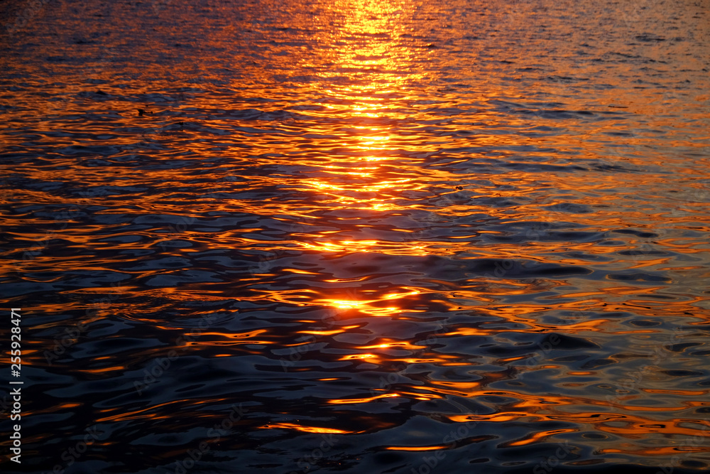 Abstract golden reflection on water sunset