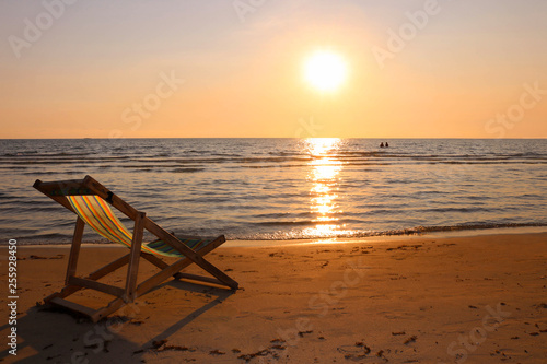 Beach chair on the tropical beach at sunset time