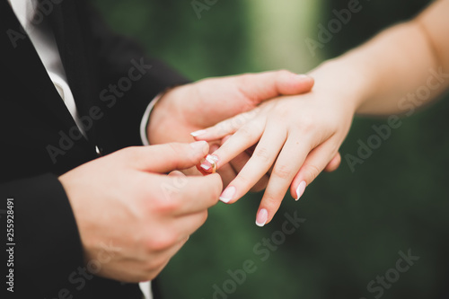 Bride and groom exchanging wedding rings. Stylish couple official ceremony