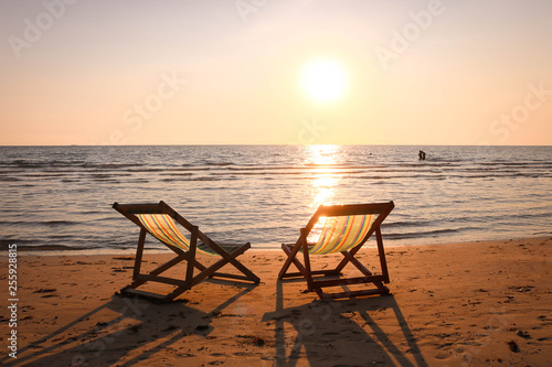 Beach chair on the tropical beach at sunset time