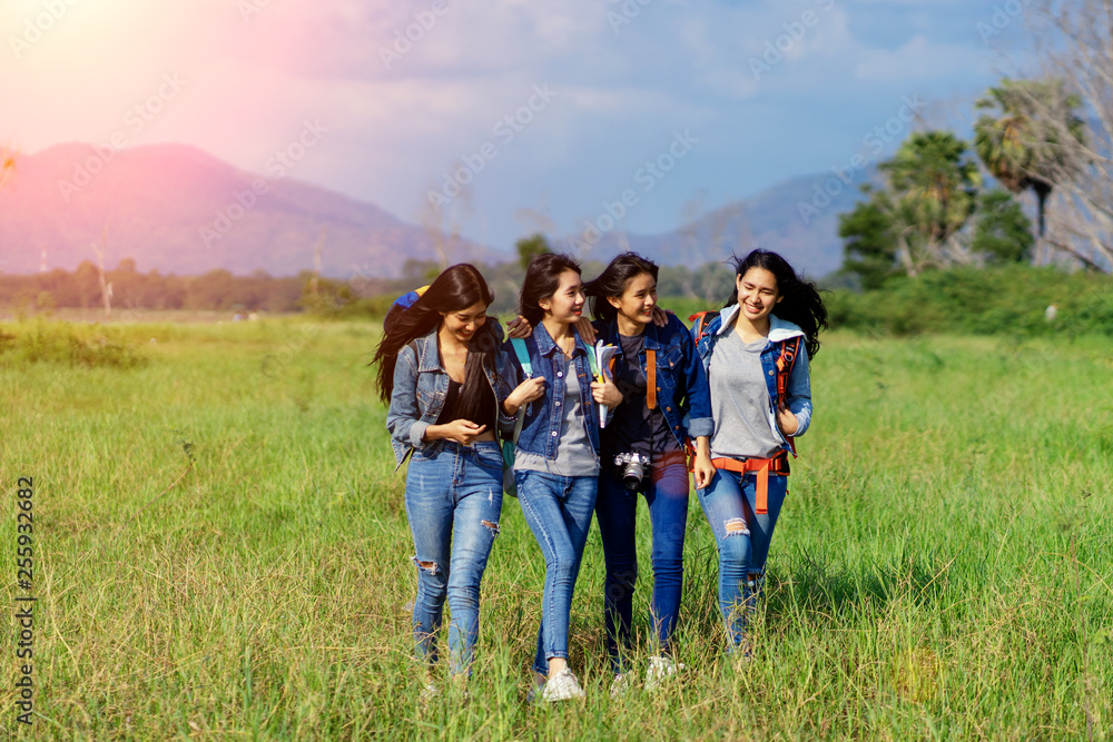 Trekking holiday concept.Four women are trekking in the mountains with backpack,tent,hiking equipment. Trekking holiday concept.Four women are trekking in the mountains with backpack,tent,hiking equipment.