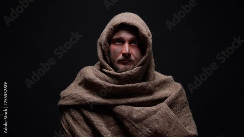 Poor male in rough robe looking directly to camera, early christian prophet photo