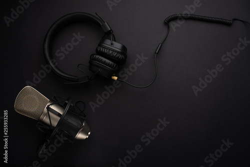 Microphone with headphones. Studio recording, broadcasting, blog, speaker. On a black background