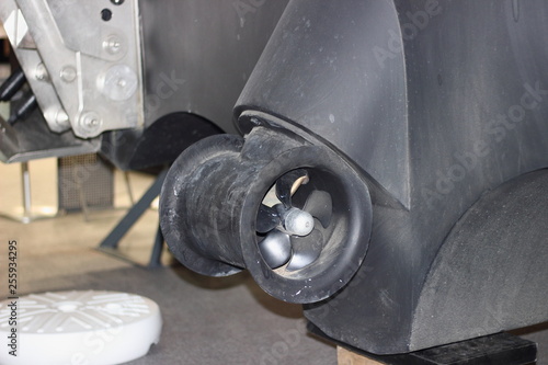 Outboard thruster propeller on the stern of a motor yacht - ship mooring court